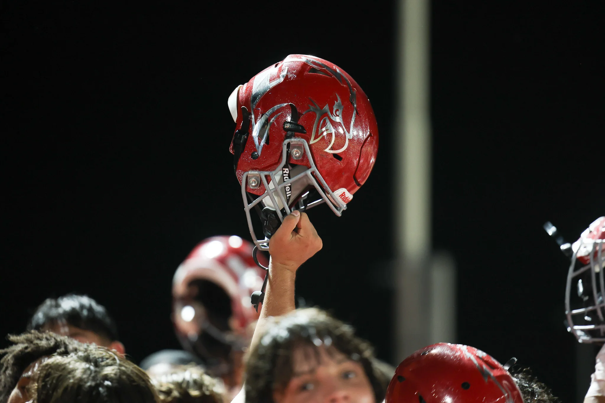 Ironwood Eagles helmet being held up high